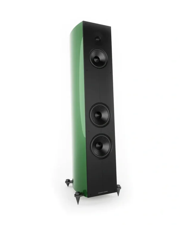 A green and black speaker on top of a white floor.