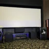 A room with speakers and a large screen