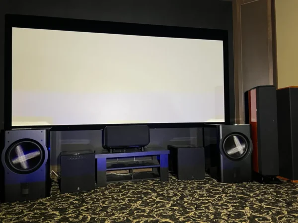 A room with speakers and a large screen