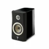 A black speaker is sitting on the floor.