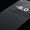 A black phone is shown with the screen displaying 6. 0