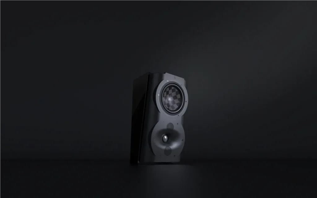 A speaker is sitting in the dark on top of a table.