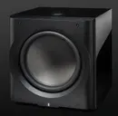 A black subwoofer sitting on top of a floor.