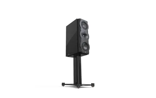 A black speaker stands on top of a metal stand.