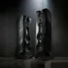 Two speakers are sitting in a room with lights.